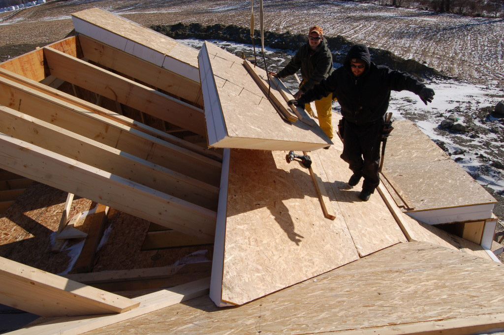 Foam Laminates employees installing SIPs on a roof