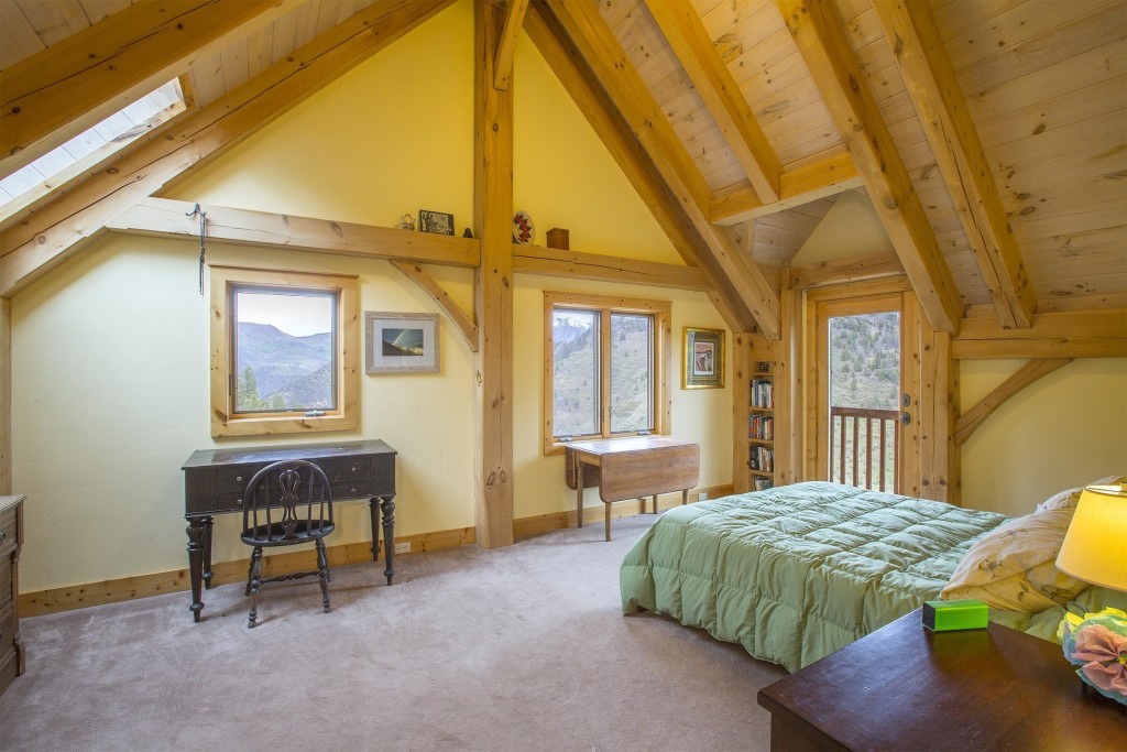 Master bedroom in a timber frame cape