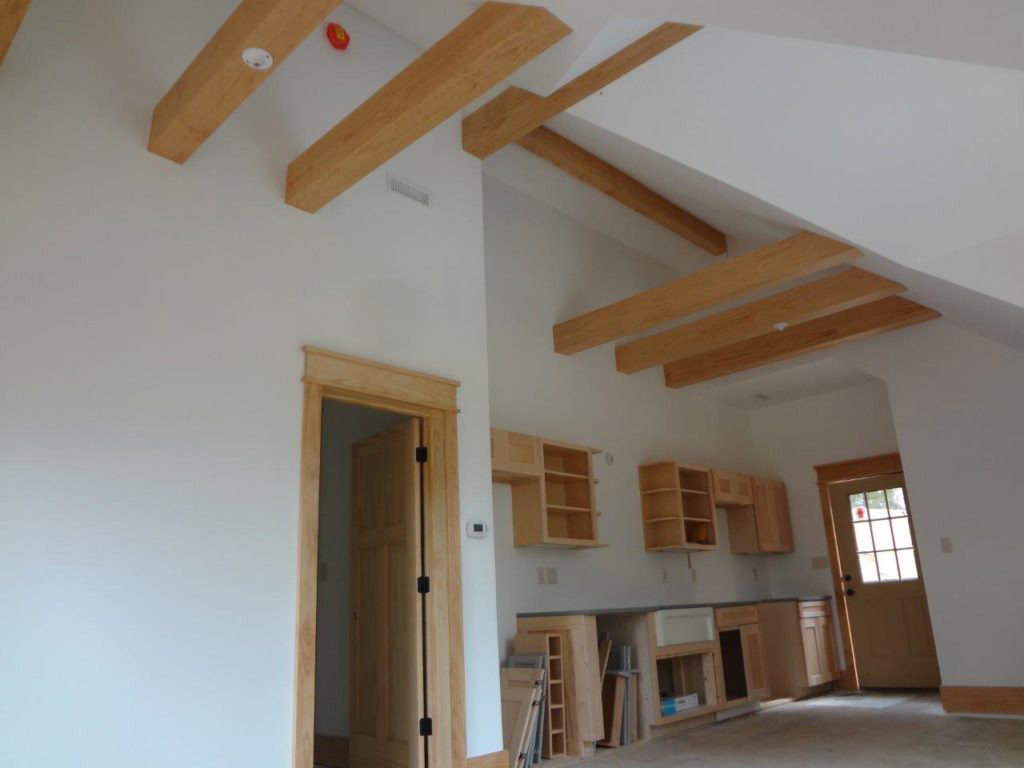 Interior ceiling beams in a timber frame dutch saltbox