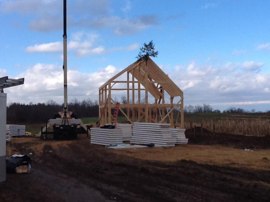 Timber frame dutch saltbox structure with SIPs and a crane