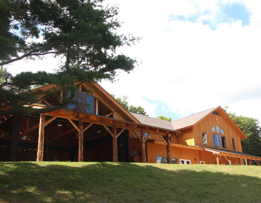 Finished exterior of a timber frame summer camp pavilion