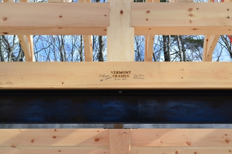 Timber frame with Vermont Frames logo and signed by the crew that built the frame